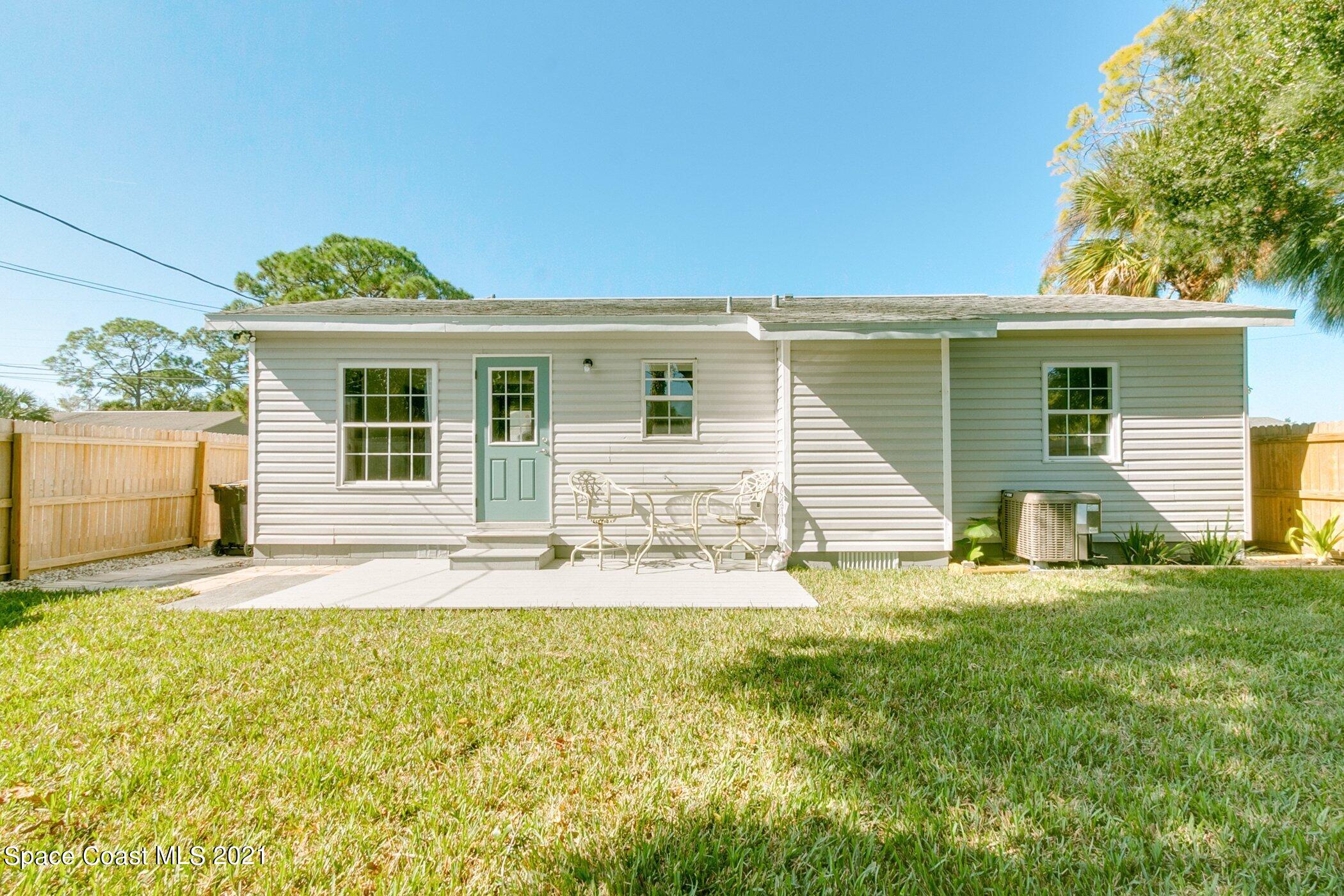 1589 Magnolia Street Northeast Palm Bay, FL 32905 - Photo 5 of 16 a front view of a house with a yard