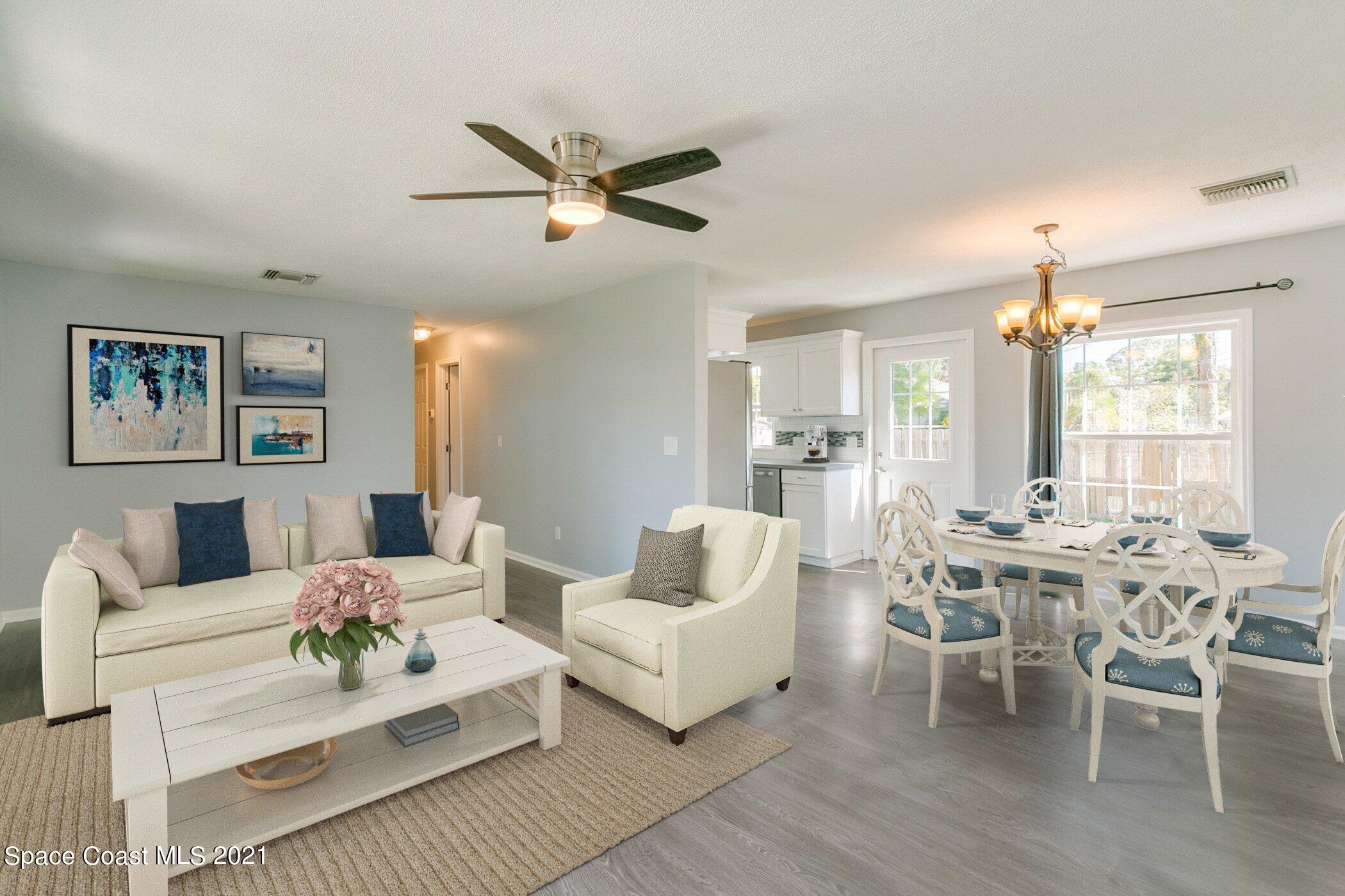 1589 Magnolia Street Northeast Palm Bay, FL 32905 - Photo 6 of 16 a living room with furniture and a chandelier