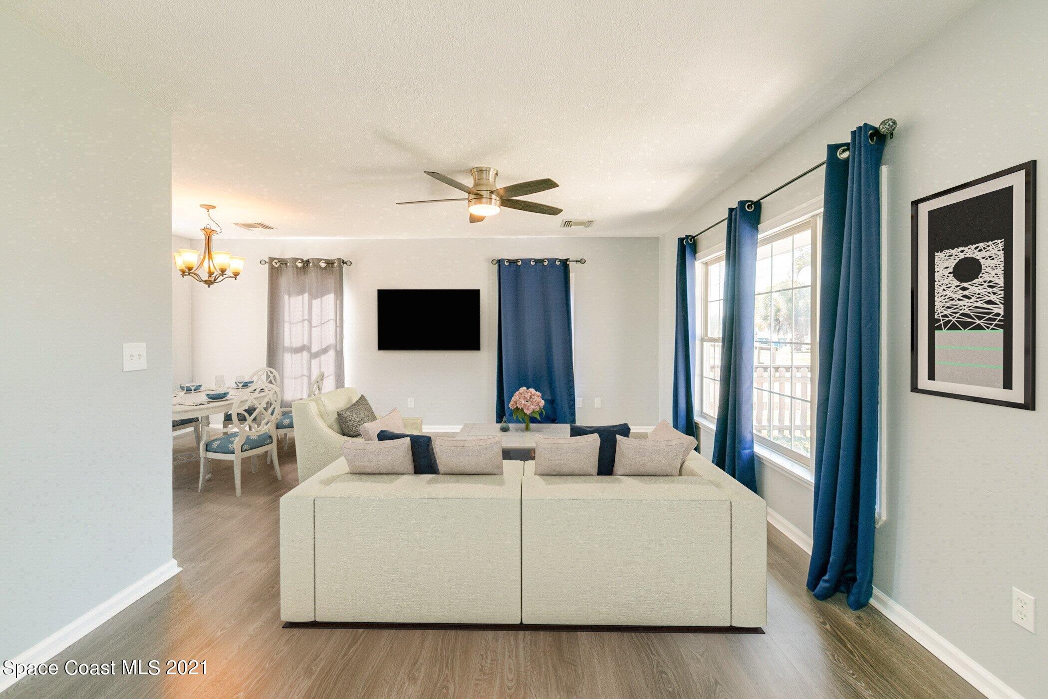 1589 Magnolia Street Northeast Palm Bay, FL 32905 - Photo 7 of 16 a living room with furniture fireplace and flat screen tv