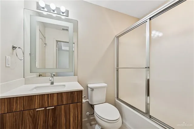 a bathroom with a toilet a sink and a mirror