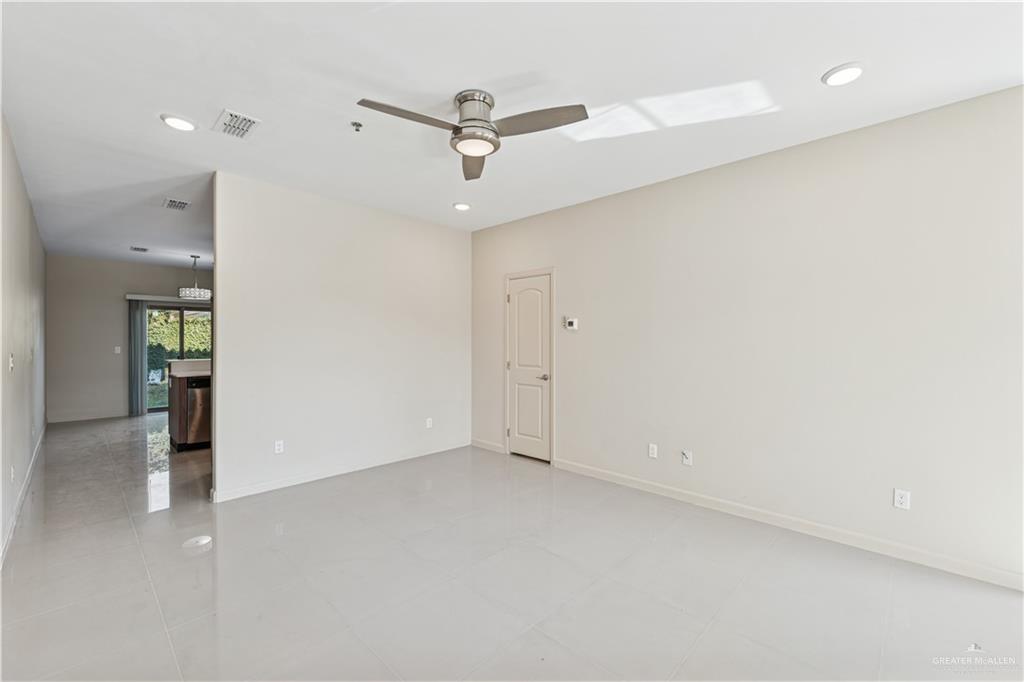 1201 East Olympia Avenue, Unit 2 McAllen, TX 78503 - Photo 3 of 15 an empty room with a ceiling fan and a window