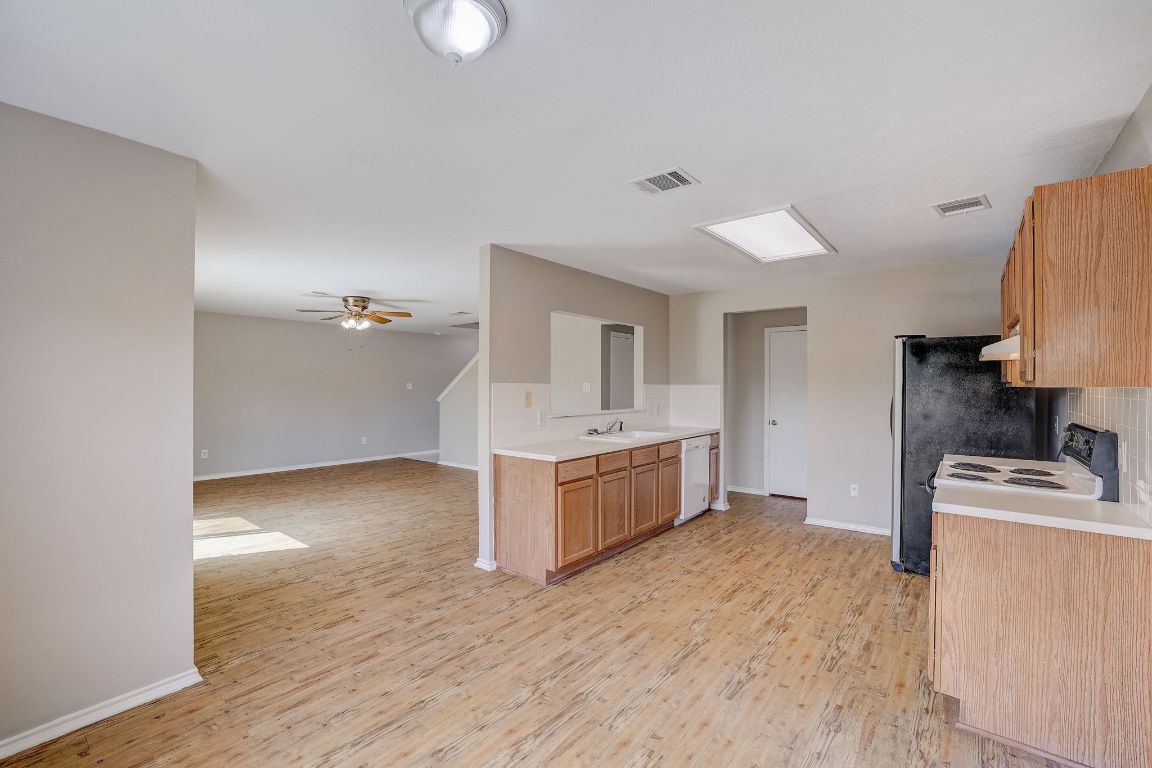 314 Bello Drive Leander, TX 78641 - Photo 11 of 35 a kitchen with a refrigerator sink and stove