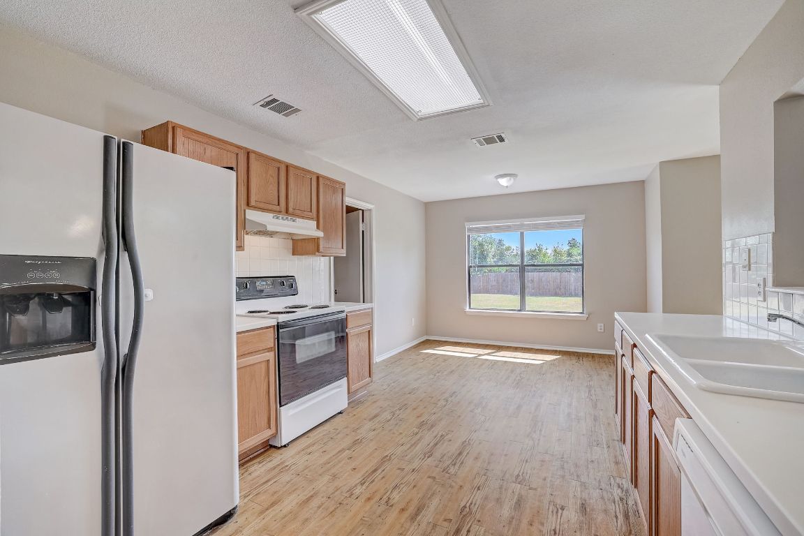 314 Bello Drive Leander, TX 78641 - Photo 14 of 35 a kitchen with stainless steel appliances a refrigerator sink and stove