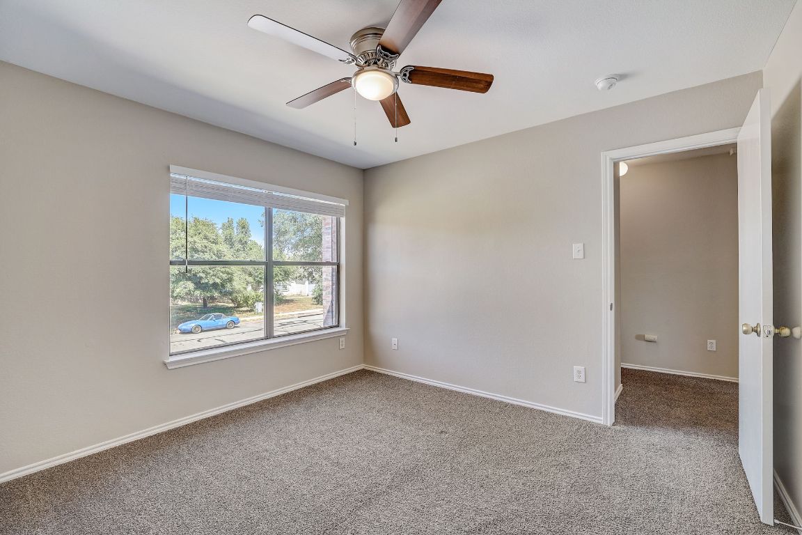 314 Bello Drive Leander, TX 78641 - Photo 24 of 35 an empty room with chandelier fan and windows