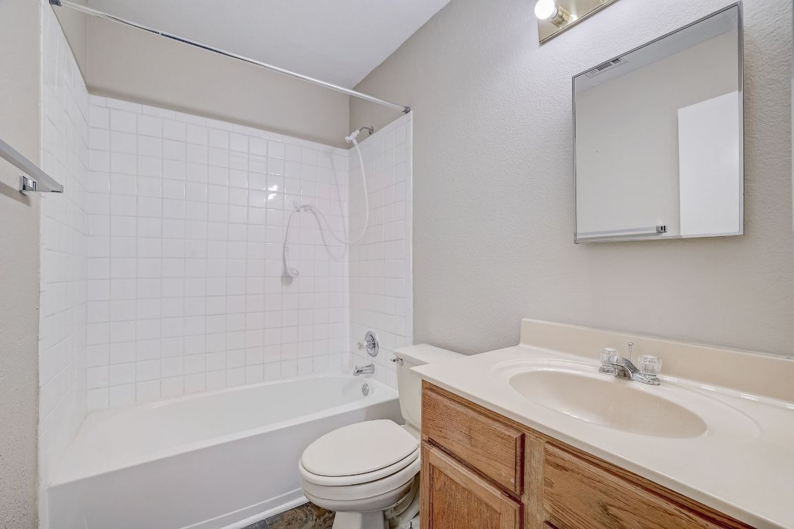 314 Bello Drive Leander, TX 78641 - Photo 25 of 35 a bathroom with a granite countertop sink toilet and shower
