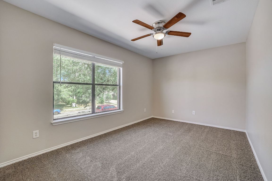 314 Bello Drive Leander, TX 78641 - Photo 28 of 35 an empty room with windows and ceiling fan
