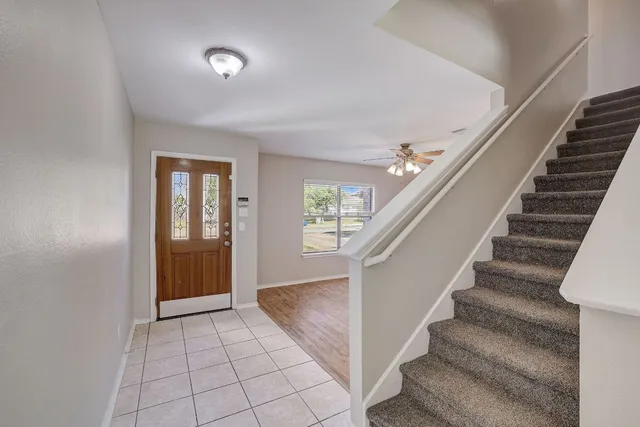 a view of entryway and hall with wooden floor