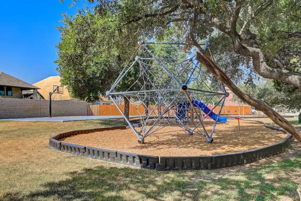314 Bello Drive Leander, TX 78641 - Photo 34 of 35 a view of a swimming pool with a sitting space
