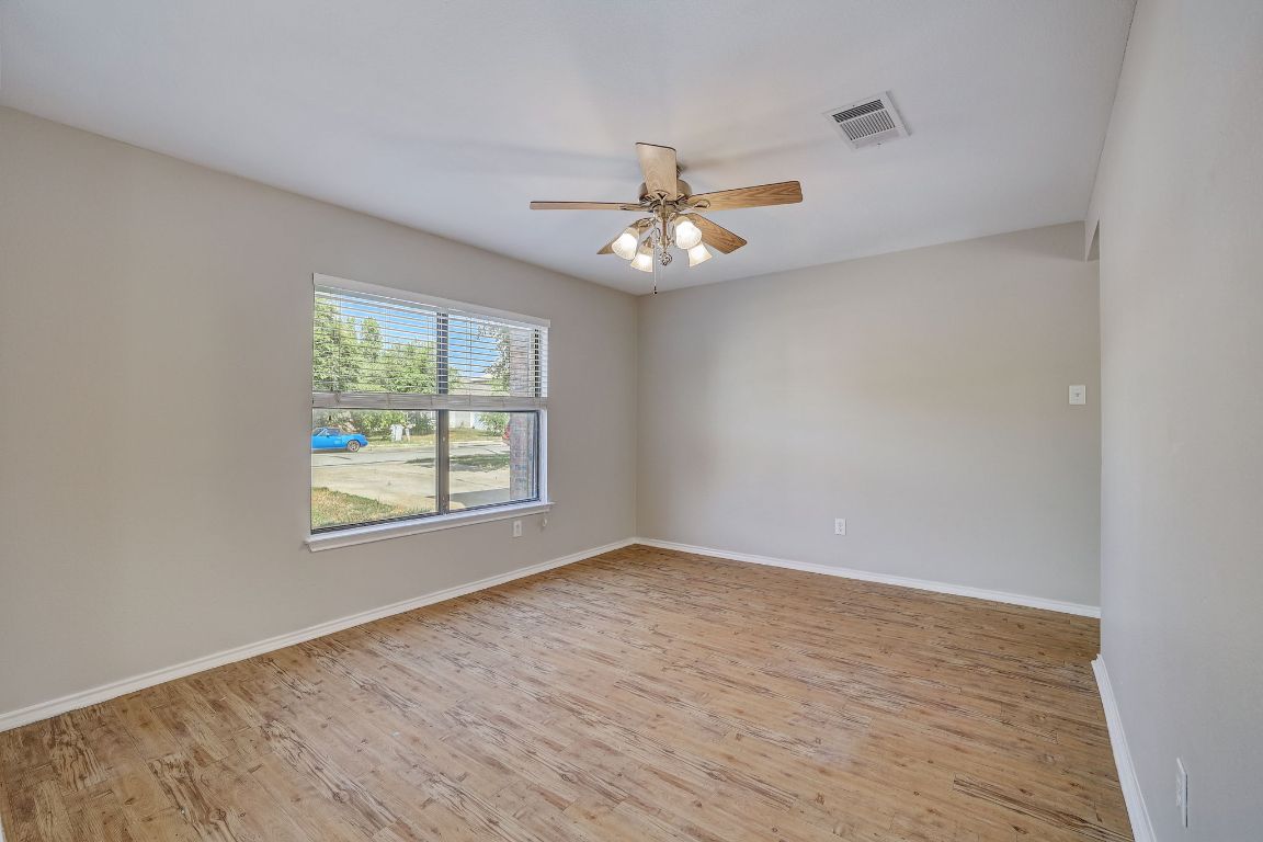 314 Bello Drive Leander, TX 78641 - Photo 4 of 35 wooden floor in an empty room with a window