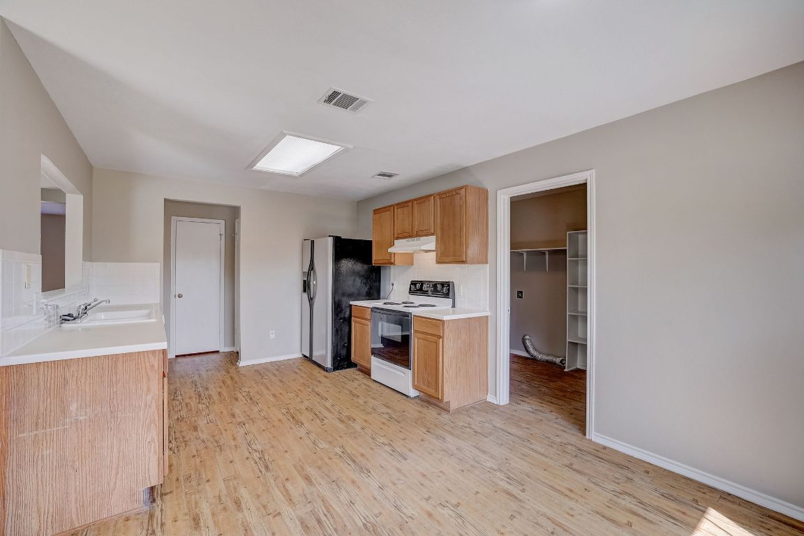 314 Bello Drive Leander, TX 78641 - Photo 10 of 35 a open kitchen with a refrigerator stove and a sink