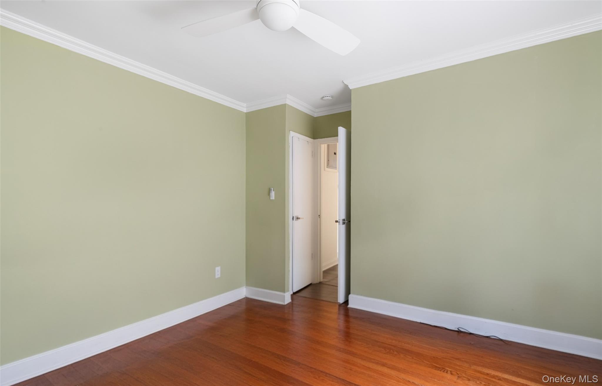 19-50 80th Street, Unit 1 Queens, NY 11370 - Photo 13 of 20 a view of an empty room with wooden floor