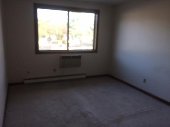 5 Turnpike Road, Unit 335 Townsend, MA 01469 - Photo 3 of 8 a view of an empty room with a window