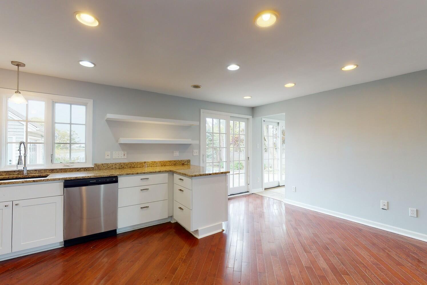 85 Roton Avenue Rowayton, CT 06853 - Photo 11 of 31 a large kitchen with granite countertop wooden floors a sink and a window
