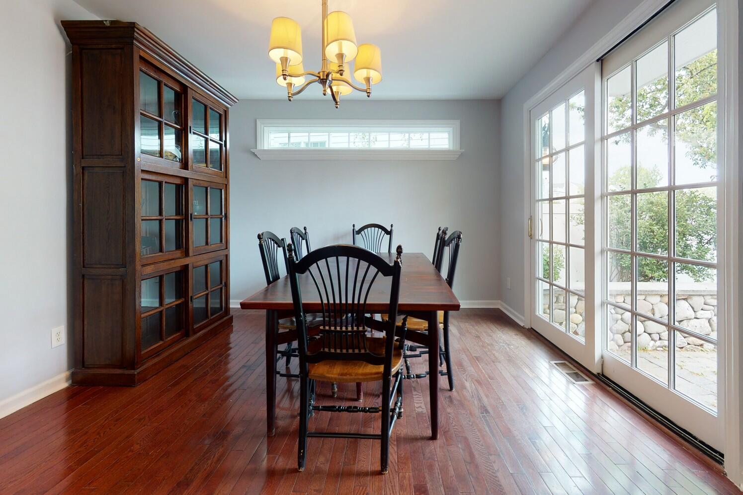 85 Roton Avenue Rowayton, CT 06853 - Photo 12 of 31 a view of a dining room with furniture a chandelier and wooden floor