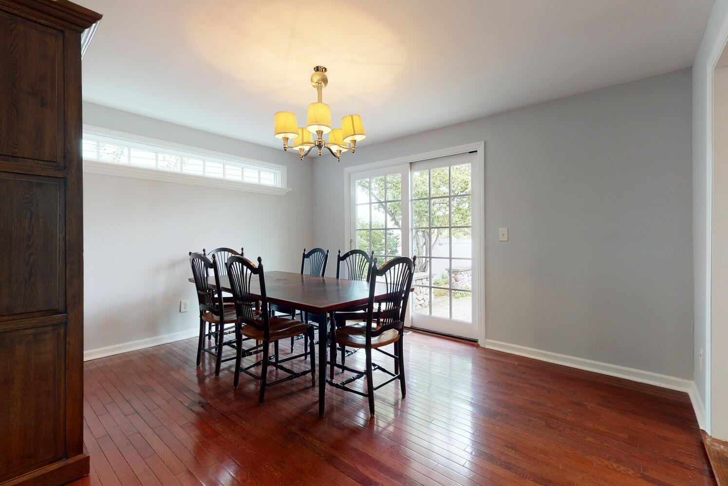 85 Roton Avenue Rowayton, CT 06853 - Photo 13 of 31 a view of a dining room with furniture a chandelier and wooden floor