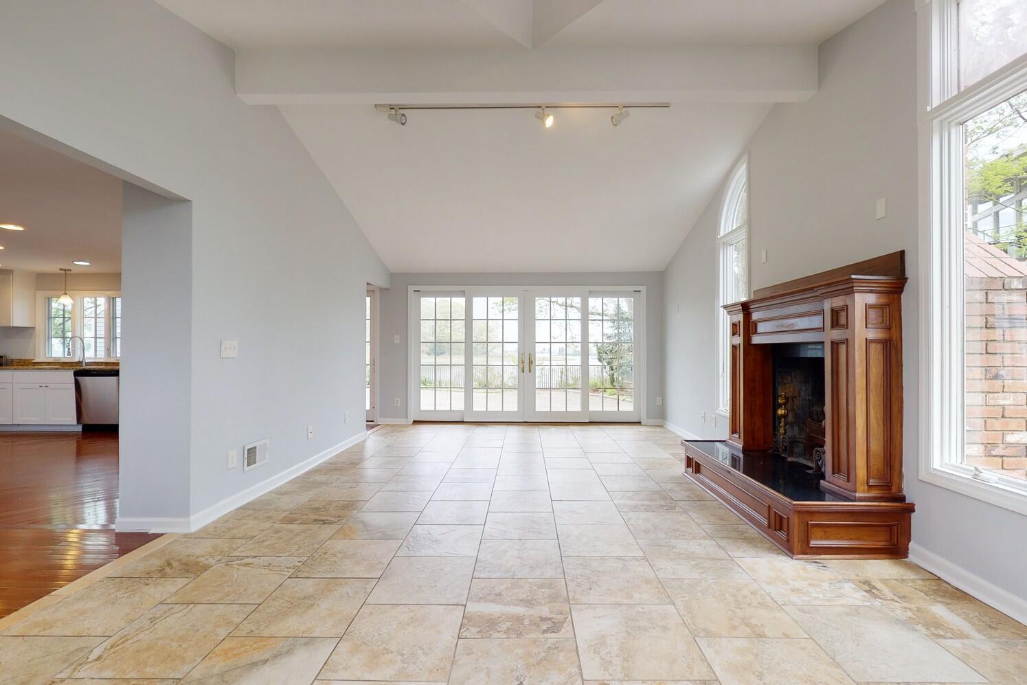 85 Roton Avenue Rowayton, CT 06853 - Photo 14 of 31 a view of an empty room with a fireplace and a window