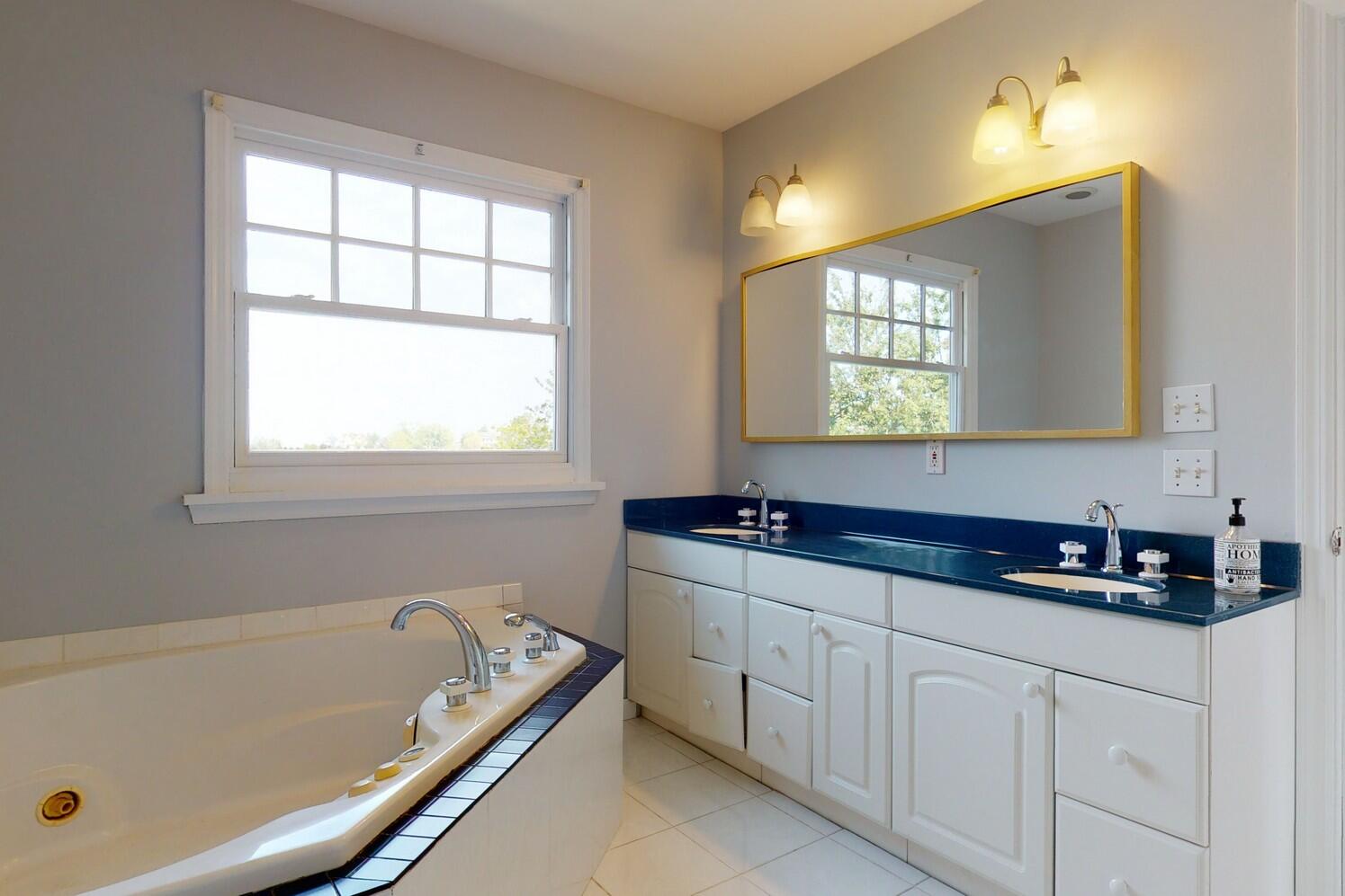 85 Roton Avenue Rowayton, CT 06853 - Photo 22 of 31 a bathroom with a tub sink and mirror