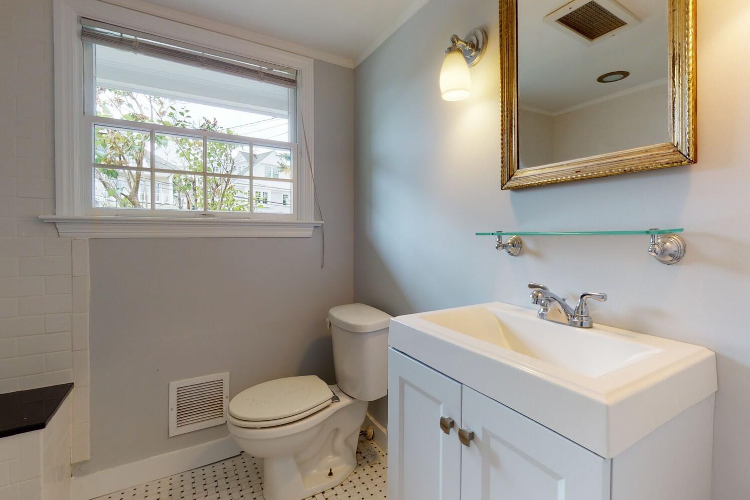 85 Roton Avenue Rowayton, CT 06853 - Photo 24 of 31 a bathroom with a sink a toilet and mirror
