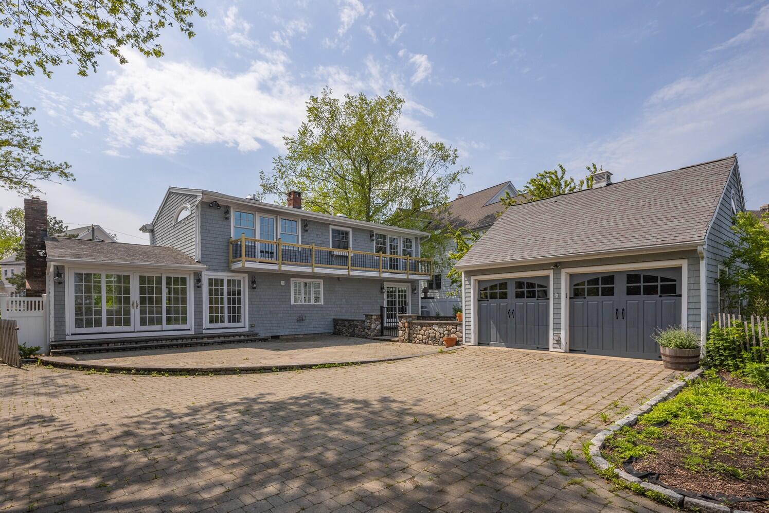 85 Roton Avenue Rowayton, CT 06853 - Photo 27 of 31 a front view of a house with a yard and potted plants