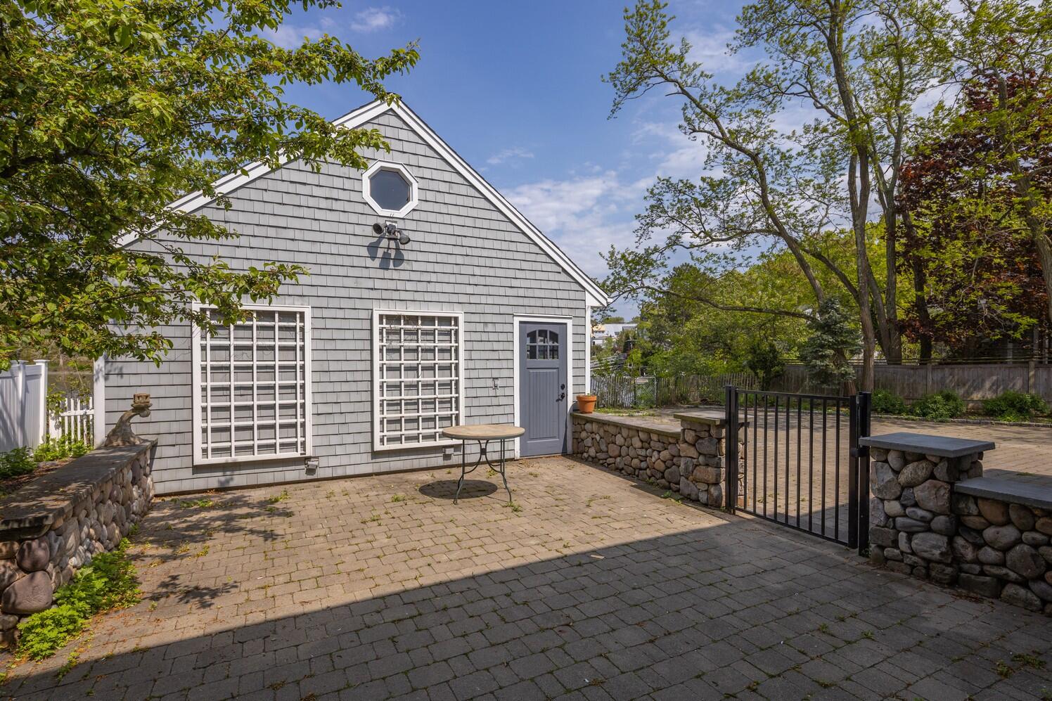 85 Roton Avenue Rowayton, CT 06853 - Photo 28 of 31 a front view of a house with a garden