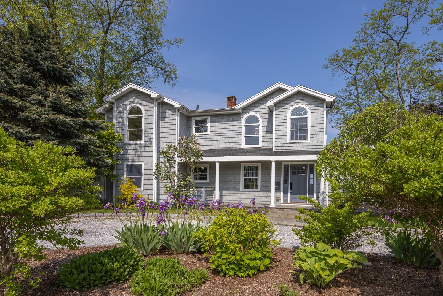 85 Roton Avenue Rowayton, CT 06853 - Photo 5 of 31 a front view of a house with a yard and trees