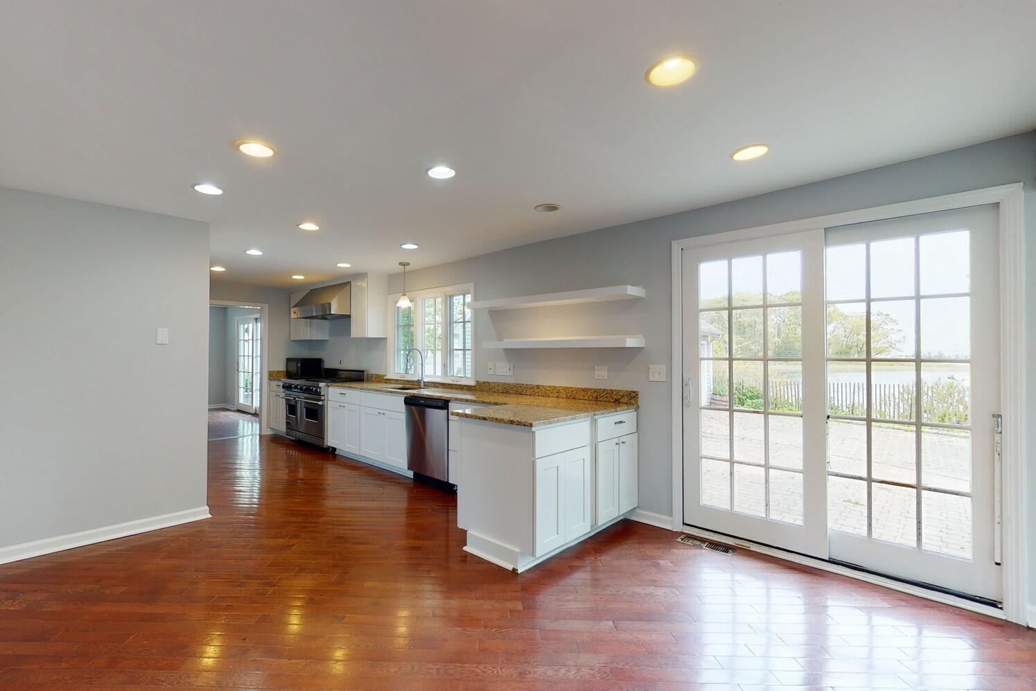 85 Roton Avenue Rowayton, CT 06853 - Photo 8 of 31 a large kitchen with stainless steel appliances granite countertop a large counter top and a stove top oven with wooden floor