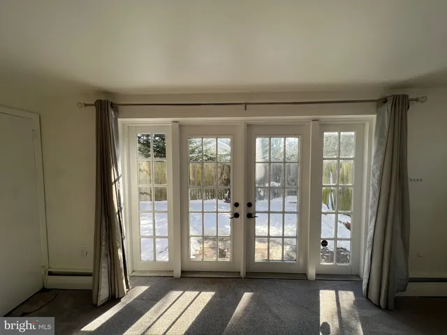 a view of empty room with floor to ceiling window