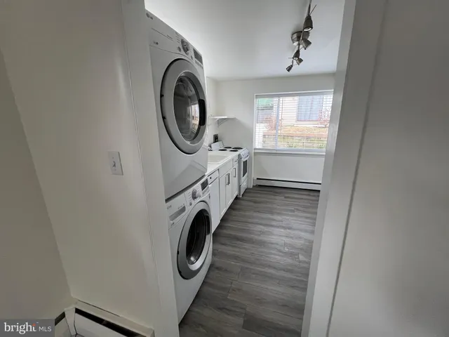 a bathroom with granite countertop a washer and dryer