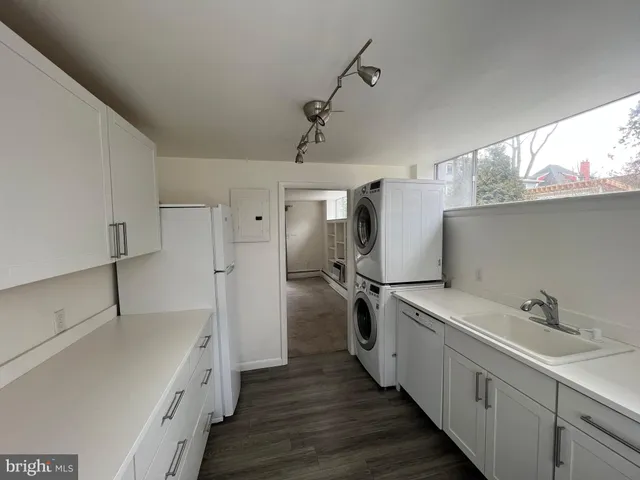 a kitchen with sink cabinets and wooden floor