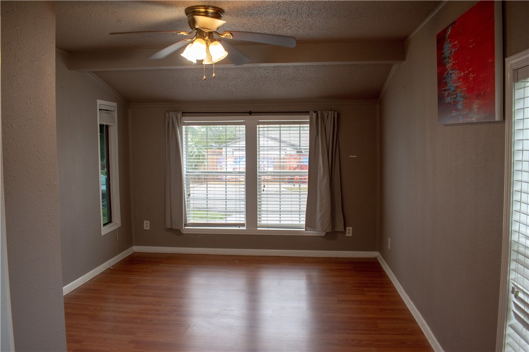 906 Rickey Drive Corpus Christi, TX 78412 - Photo 13 of 40 a view of an empty room with wooden floor and a window
