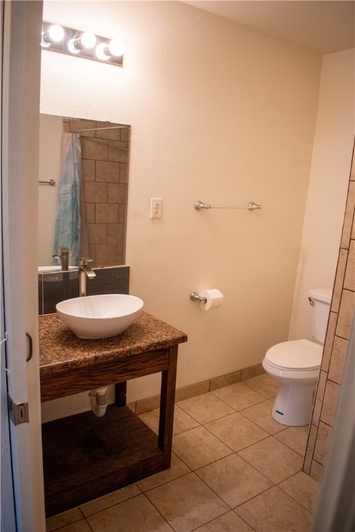 906 Rickey Drive Corpus Christi, TX 78412 - Photo 20 of 40 a bathroom with a granite countertop sink a toilet a mirror and vanity