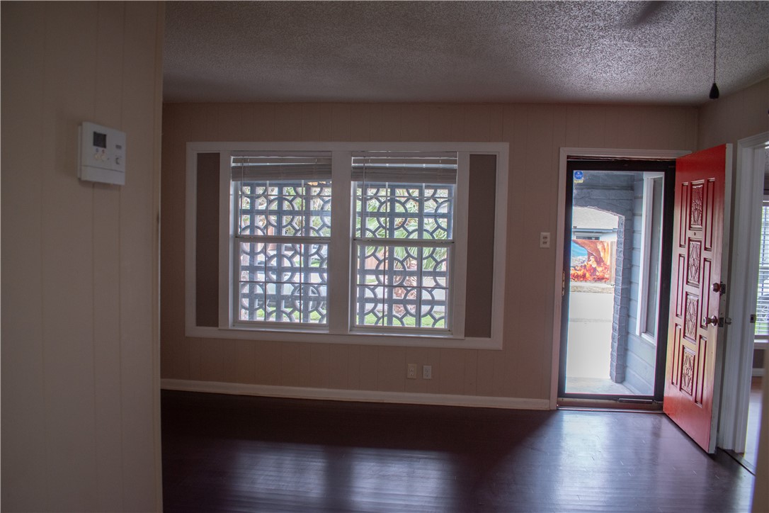 906 Rickey Drive Corpus Christi, TX 78412 - Photo 5 of 40 an empty room with wooden floor and windows