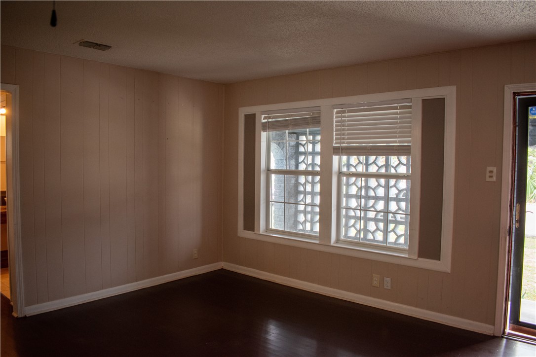 906 Rickey Drive Corpus Christi, TX 78412 - Photo 6 of 40 a view of an empty room with wooden floor and a window
