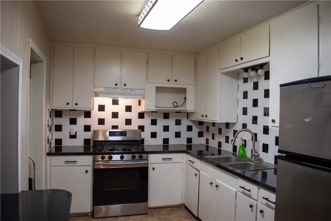 906 Rickey Drive Corpus Christi, TX 78412 - Photo 7 of 40 a kitchen with granite countertop a sink and a stove