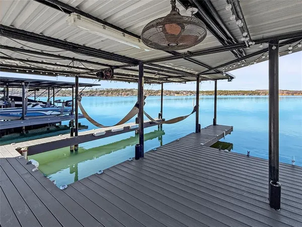 a view of a lake with table and chairs