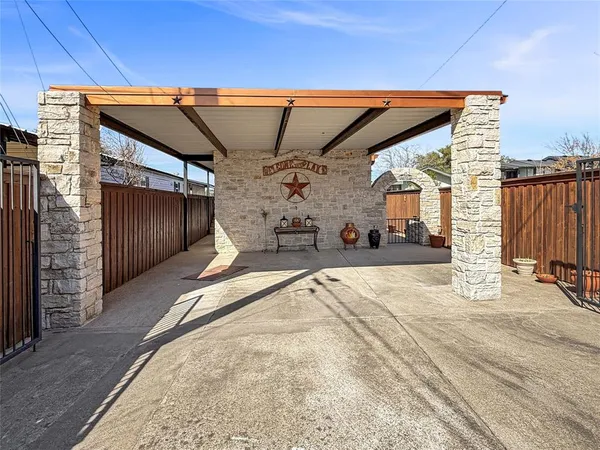 a kitchen with granite countertop a stove a sink and a refrigerator