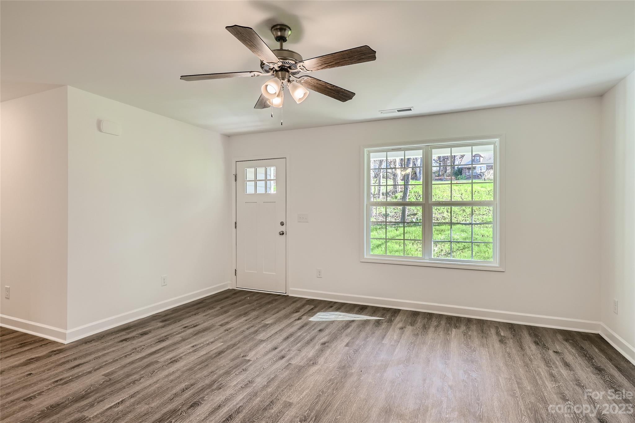 1 Hampton Church Road Charlotte, NC 28262 - Photo 2 of 11 a view of an empty room with wooden floor and a window