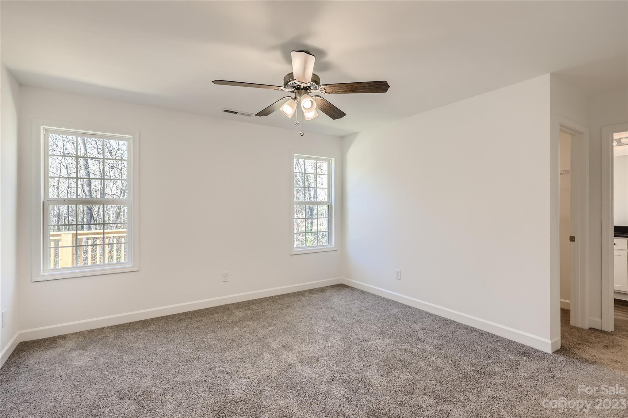 1 Hampton Church Road Charlotte, NC 28262 - Photo 5 of 11 an empty room with windows and fan