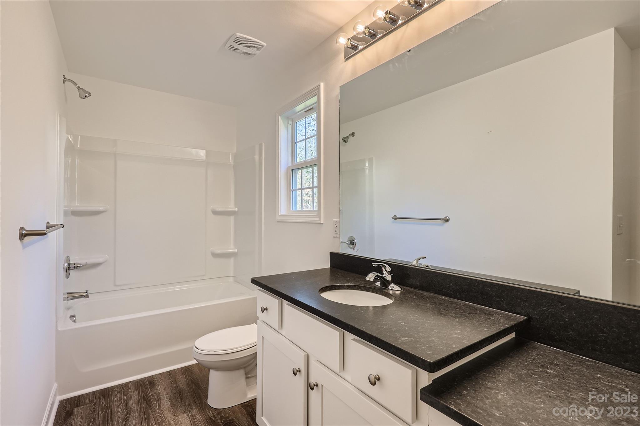 1 Hampton Church Road Charlotte, NC 28262 - Photo 6 of 11 a bathroom with a sink a toilet and shower