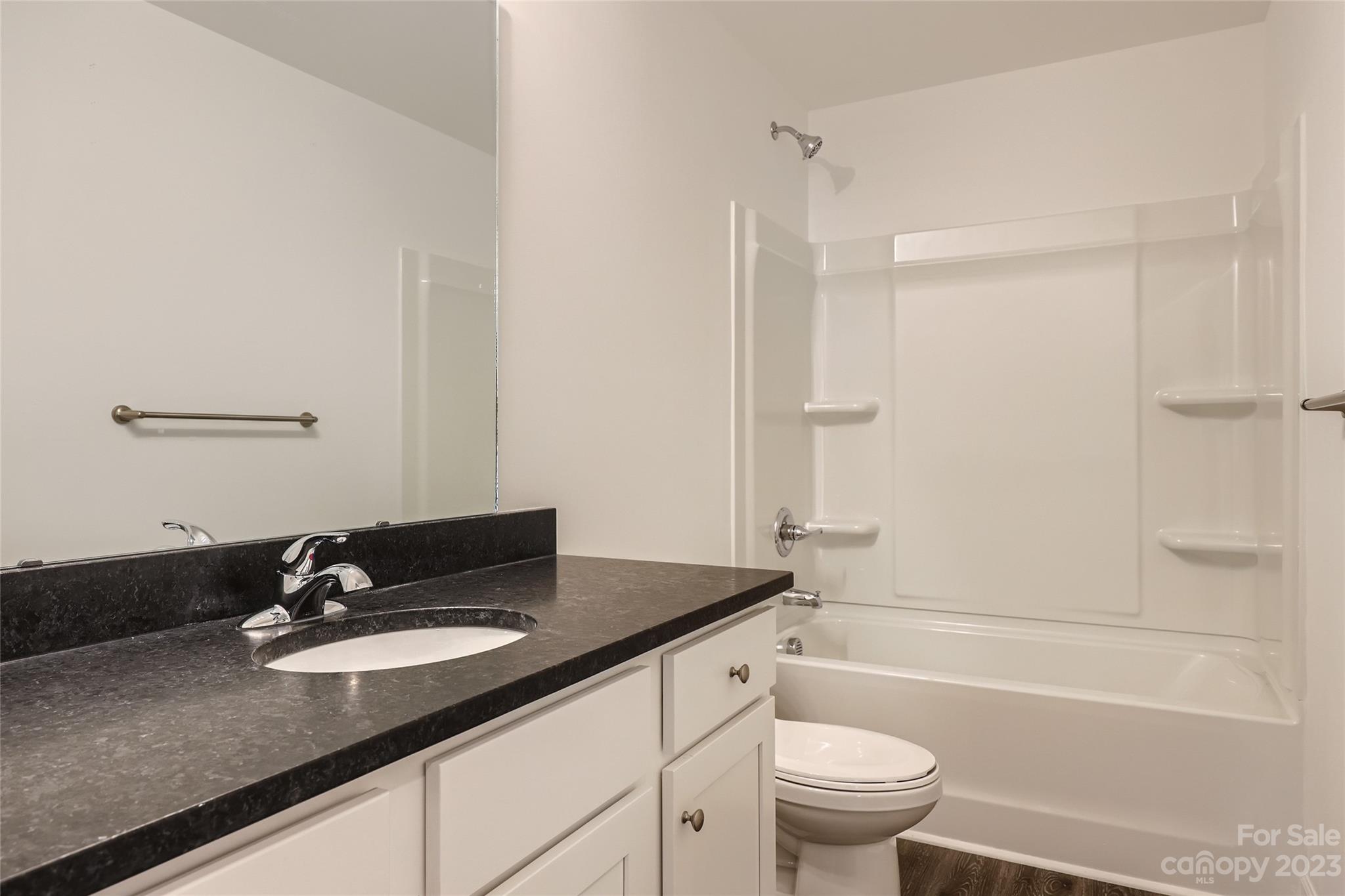 1 Hampton Church Road Charlotte, NC 28262 - Photo 8 of 11 a bathroom with a granite countertop sink toilet a mirror and shower