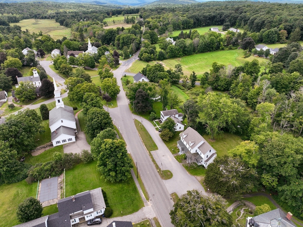 67-69 Petersham Road Hardwick, MA 01037 - Photo 6 of 38 an aerial view of a city with lots of residential buildings and mountain view in back