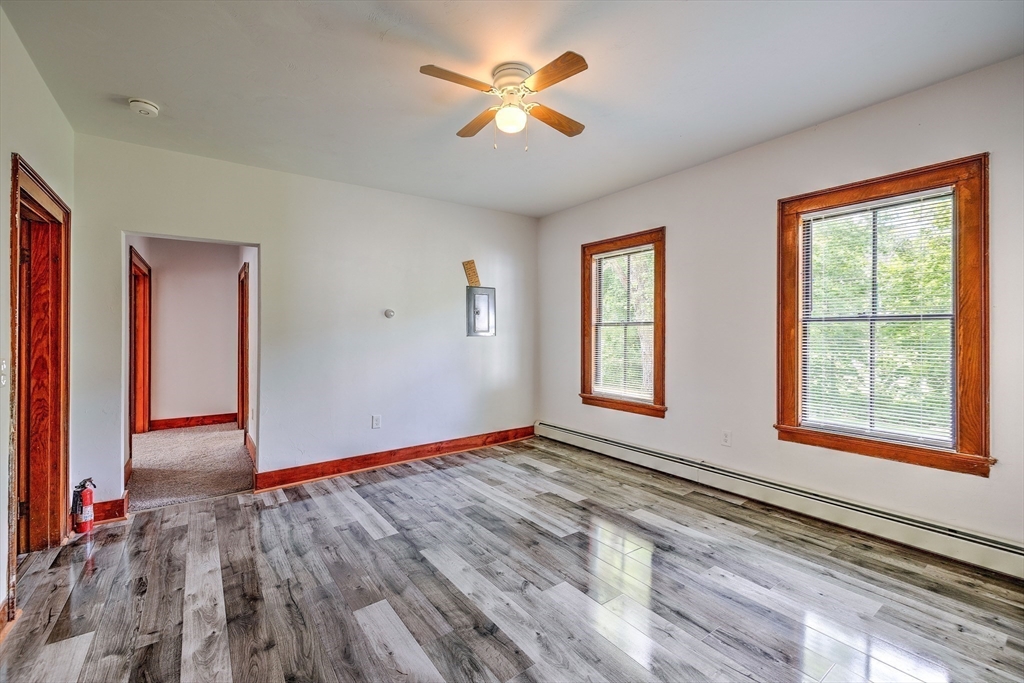 67-69 Petersham Road Hardwick, MA 01037 - Photo 7 of 38 a view of an empty room with window and a chandelier fan