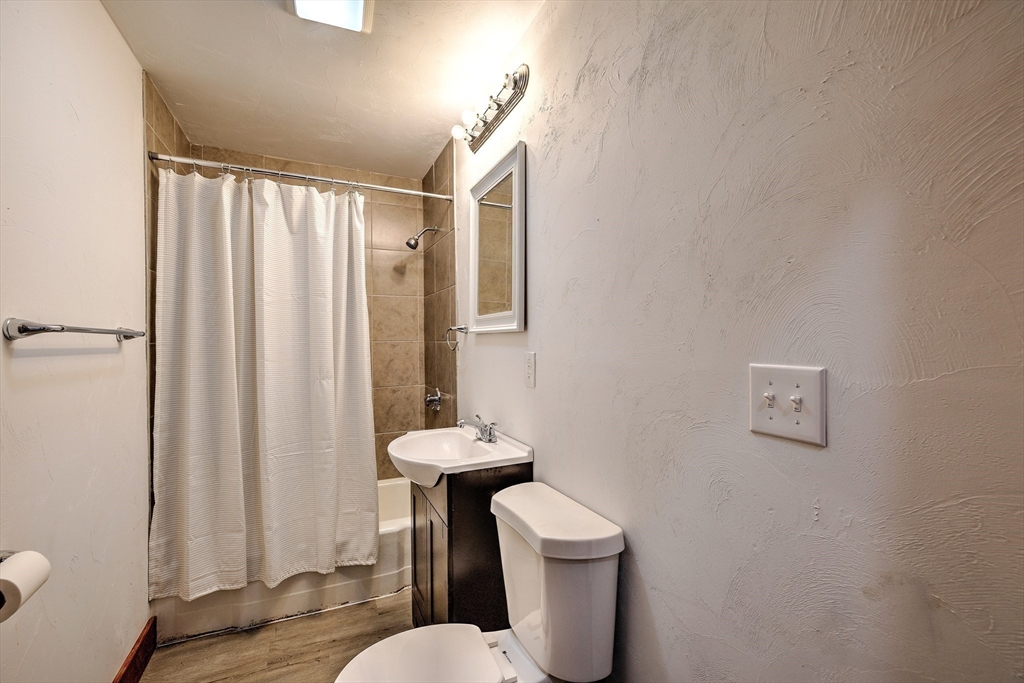 67-69 Petersham Road Hardwick, MA 01037 - Photo 9 of 38 a white toilet sitting next to a shower curtain