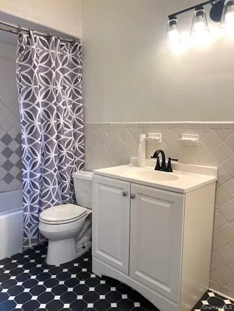 a bathroom with a sink toilet and a mirror