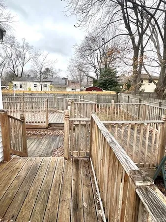 a view of balcony with wooden floor and fence