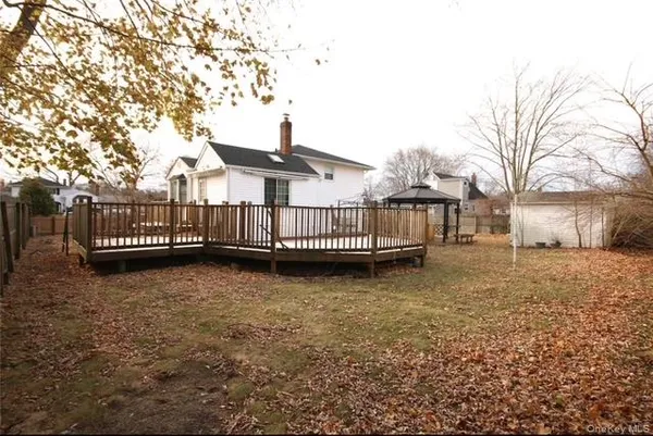 a view of a house with wooden fence