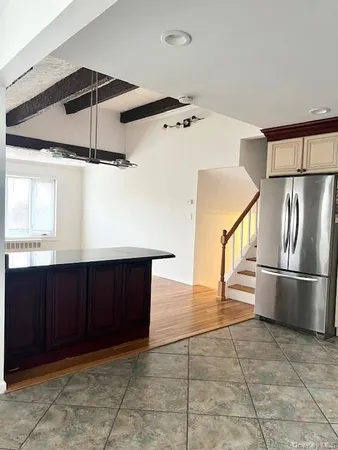 a kitchen with stainless steel appliances granite countertop a refrigerator and a sink