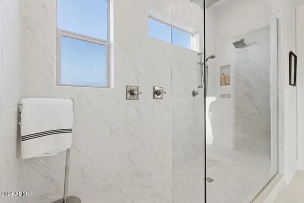 a bathroom with a granite countertop sink a toilet a mirror and shower curtain
