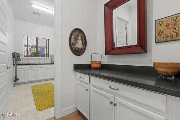 a backyard of a house with fountain table and chairs