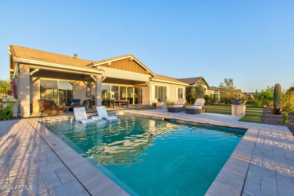 a view of swimming pool with seating space